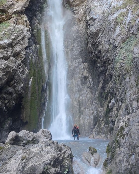 Canyoning under a waterfall