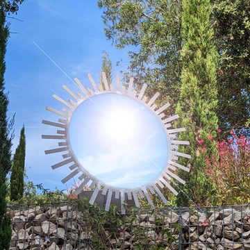 La Fleur de Soleil mirror sculpture in a garden